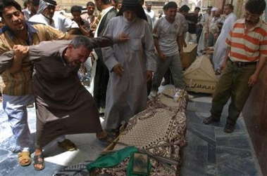 An Iraqi man grieves over the coffin of Shi'ite cleric Hashim Attiyah during his funeral in Najaf, Iraq Friday, July 8, 2005. Attiyah, a representative of Iraqi Shiite Grand Ayatollah Ali al-Sistani, died in an attack on his vehicle on Thursday, according to police. (AP