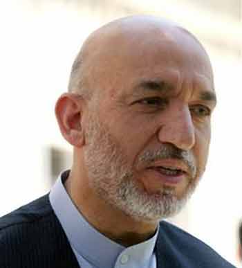 Afghan president Hamid Karzai speaks to reporters during a press conference in the Presidential Palace in Kabul, Afghanistan, Friday, July 8, 2005. Karzai urged the world to unite to combat terrorism and said the blasts in London were 'an attack against the whole of mankind.' (AP