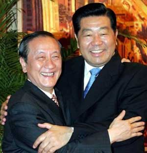 Jia Qinglin, right, chairman of the National Committee of the Chinese People's Political Consultative Conference (CPPCC), embraces Yok Mu-ming, chairman of the New Party in Taiwan, during their meeting at the Great Hall of the People in Beijing, capital of China, on July 10, 2005.