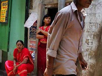 Prostitutes wait for customers at Sonagachi, the biggest red light district in Calcutta, July 9, 2005. REUTERS
