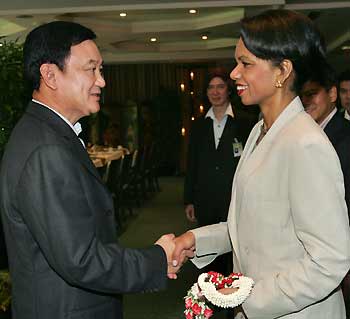 U.S. Secretary of State Condoleezza Rice (R) shakes hands with Thailand's Prime Minister Thaksin Shinawatra at Sheraton Laguna resort on Phuket Island, Thailand July 11, 2005. Rice is in Thailand for a two-day visit to examine reconstruction efforts following the devastating December 26 tsunami. [Reuters]