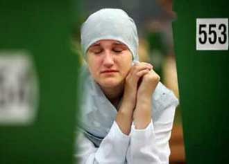 A Bosnian Muslim woman cries by a grave of her relative during a mass funeral in Potocari July 11, 2005. Relatives wept over more than 600 coffins of victims of the Srebrenica massacre, dug out of death pits at a ceremony to mark the 10th anniversary of Europe's worst atrocity in 50 years. The coffins contained the latest identified remains found in mass graves dug by Bosnian Serb forces to hide their slaughter of 8,000 Muslim men between July 11 and July 18, 1995. ($Byline$/Reuters) 