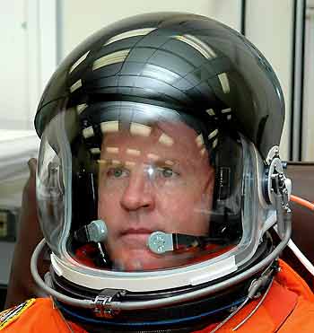 Australia-born astronaut Andrew Thomas tries the fit on his flight helmet before departing for the pad before launch of the space shuttle Discovery at the Kennedy Space Center in Cape Canaveral, Florida, July 13, 2005. [Reuters]
