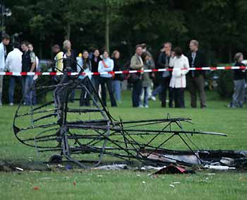 Police tape off the wreckage of a small aircraft following a crash in front of the Reichstag in Berlin late July 22, 2005