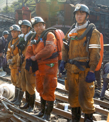Chinese rescuers are ready to enter a coal mine pit for a rescue mission in the city of Fukang, Northwest China's Xinjiang Autonomous Region July 11, 2005. Twenty-two miners were killed and 60 others were missing after a gas explosion ripped through the Shenlong Mine. [Xinhua]