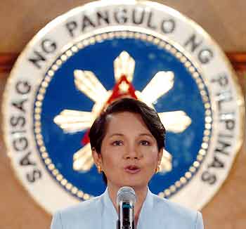 Philippine President Gloria Macapagal Arroyo speaks during a news conference with local reporters in Malacanang presidential palace in Manila July 27, 2005.