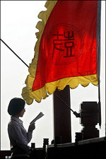 A woman finds quiet solitude from the balcony atop Beijing's Drum Tower to practice her oral English. China is casting such a huge shadow on the United States that many Americans are scrambling to learn the Chinese language in a bid to retain their competitive edge.(AFP