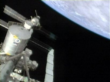 A television camera on the space shuttle Destiny shows the International space station as the two docked crafts orbit the Earth Sunday, July 31, 2005. (AP 