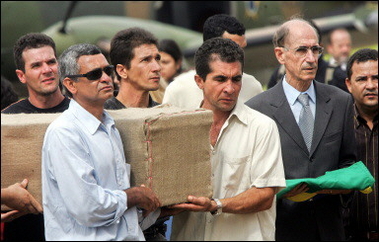 The relatives of Jean Charles de Menezes carry his coffin after it arrives in Brazil.