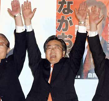 Yoji Nagaoka, a lawmaker of the ruling Liberal Democratic Party (LDP) who opposed Japan's postal reform bills at an LDP party meeting but voted in favour in parliament, shouts banzai cheers as he celebrates a Lower House election victory at his campaign office in Sowa town, northeast of Tokyo in April 2003.