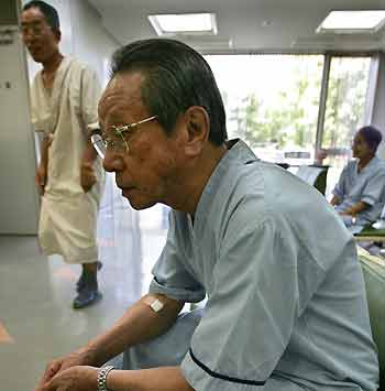 Atomic bomb survivor Kaneo Kimura waits his turn for an x-ray examination during a mass medical check-up in Hiroshima August 5, 2005. Kimua was 2.4 km (1.4 miles) away from the site of the explosion that killed his father, brother and cousins. Hiroshima is marking the 60th anniversary of the world's first atomic bombing on August 6, which instantly took thousands of lives, with the death toll rising to some 140,000 by the end of 1945 out of the city's estimated population of 350,000.