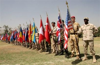 Soldiers from different nationalities hold flags of their countries during the ISAF (International Security Assistance Force) change of command ceremony in Kabul, Afghanistan, Thursday, Aug. 4, 2005, where Italy took over the command from Turkey.