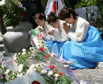 South Korean residents in Japan offer prayers in front of a cenotaph dedicated to South Korean atomic bomb victims at Peace Memorial Park in Hiroshima August 5, 2005, on the eve of the 60th anniversary of the world's first atomic bombing of the city. REUTERS