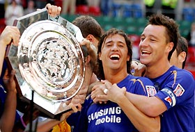 Chelsea's John Terry (R) and Hernan Crespo (L) celebrate after defeating Arsenal in their English Community Shield soccer match at the Millennium Stadium in Cardiff, Wales, August 7, 2005. Chelsea won the match 2-1. 