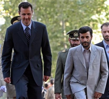 Syrian President, Bashar Assad, left, and his Iranian counterpart, Mahmoud Ahmadinejad, make their way during his welcoming ceremony, in Tehran, Iran, Sunday, Aug. 7, 2005. Assad arrived in Tehran Sunday for a two-day official visit to Iran. (AP