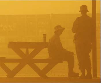 Two female US soldiers of 550th Medical Section of 3rd Infantry Division share their short break in the sandstorm in the Camp Taji, northwestern of Baghdad. 