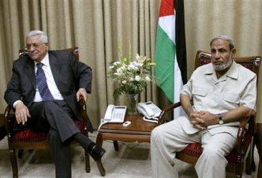 Palestinian Authority President Mahmoud Abbas, also known as Abu Mazen, left, looks on during a meeting with Hamas representative Mahmoud Zahar in the Palestinian Authority's headquarters in Gaza City, Tuesday, Aug. 9, 2005. 