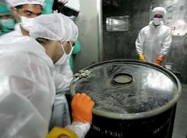 An Iranian worker lifts a barrel of 'yellow cake' at the Uranium Conversion Facility (UCF) in Isfahan, August 8, 2005. [Reuters]
