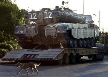A truck carrying an Israeli army tank leaves the Jewish settlement of Gadid, in the southern Gaza Strip, Wednesday Aug. 10, 2005. The Israeli government is planning to evacuate all Jewish settlements from the Gaza Strip and four in the northern West Bank by mid-August. (AP