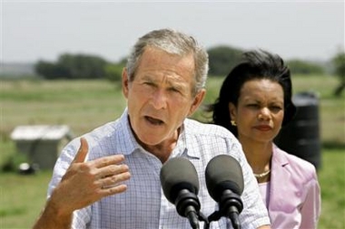 President Bush, joined at right by Secretary of State Condoleezza Rice, talks to reporters after meeting with his defense and foreign policy teams at his ranch in Crawford, Texas, Thursday, Aug. 11, 2005. 