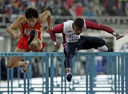 Terrence Trammell of the U.S. (R) and Liu Xiang of China clear hurdles during their men's 100 metres hurdles semi-final at the world athletics championships in Helsinki August 11, 2005. Trammell finished first in the semi-final, while Liu was second. 