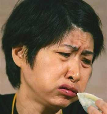 A participant struggles to swallow the vegetarian dumplings during the dumpling eating contest in Hong Kong Saturday, Aug. 13, 2005.