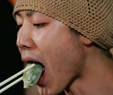 The World Hotdog Eating Champion Takeru Kobayashi of Japan eats dumplings while competing with several participants in the 'Stomach of the World' eating contest in Hong Kong August 13, 2005.