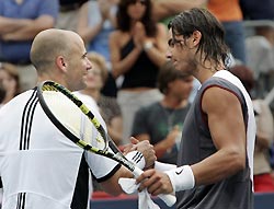 Spain's Rafael Nadal (R) greets Andre Agassi of the U.S. following the finals of the Montreal Masters tennis tournament in Canada August 14, 2005. Nadal won the match 6-3 4-6 6-2. 