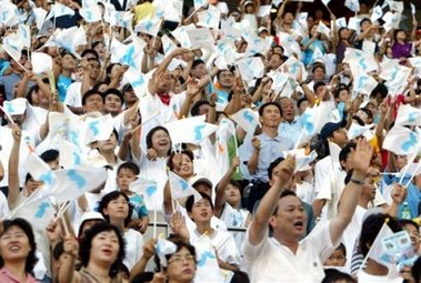 South Koreans wave reunification flags during the friendly match between South and North Korea marking the 60th anniversary of liberation, at the World Cup Stadium in Seoul, South Korea, Sunday, Aug. 14, 2005. 