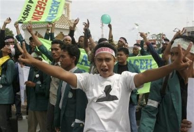 Acehnese student shouts 'peace' as they hold a demonstration to support the peace agreement between the Indonesian government and Free Aceh Movement in Banda Aceh, Indonesia, Sunday August 14, 2005.