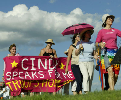 Dozens of women march with a giant letter addressed to U.S. first lady Laura Bush along a road towards the ranch of vacationing U.S. President George W. Bush in Crawford, Texas, August 18, 2005. Dozens of letters, addressed to first lady Bush appealing for her compassion to influence President Bush, were handed to White House representative Bill Burck after the women marched to a police checkpoint near the ranch. [Reuters]