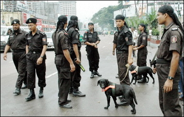 Bangladeshi 'Rapid Action Battalion' (RAB) forces guard a street in Dhaka. Bangladesh security forces arrested almost 90 people in connection with a wave of simultaneous bombings that police said were linked to a banned group of Muslim extremists.(AFP