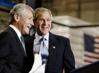 U.S. President George W. Bush (R) is introduced by U.S. Senator Chuck Hagel while pushing his jobs and growth plan during his visit to Airlite Plastics in Omaha, Nebraska, in this May 12, 2003 file picture. [Reuters]