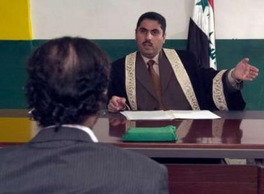A handout photograph released by the Iraqi Special Tribunal on August 23, 2005 shows former Iraqi president Saddam Hussein (L) being questioned by Chief Investigative Judge Raid Juhi at an undisclosed location.