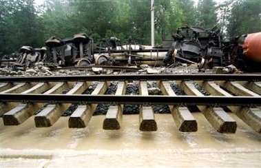 A train lies at the side of the track, derailed by floods near the village Nenzing in Vorarlberg, western province of Austria on Tuesday, Aug. 23, 2005. 