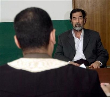 A handout photograph released by the Iraqi Special Tribunal on August 23, 2005 shows former Iraqi president Saddam Hussein (R) being questioned by Chief Investigative Judge Ra'id Juhi at an undisclosed location. A statement released with the photograph said that it was taken on Tuesday, and that Saddam confirmed that he had fired his entire defense team, except for Khalil Dulaimi. 