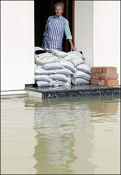 Edith Stoeckl looks out of her house on in Moos, southern Germany and watches the rising water of the Donau river. Record flooding in southern Germany surged downstream from the Alps.(