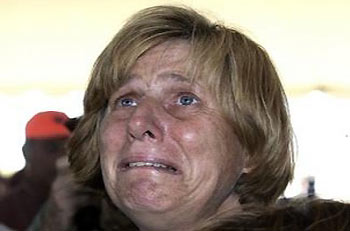 Cindy Sheehan cries after seeing a portrait of her son, Army Spc. Casey Sheehan who was killed in Iraq, at Camp Casey next to President Bush's ranch in Crawford, Texas, Wednesday, Aug. 24, 2005. Sheehan returned to Texas and her anti-war vigil after a weeklong absence for a family emergency. [AP Photo]