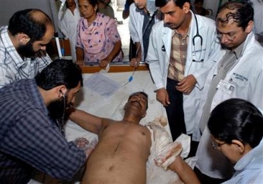 Pakistani doctor and para-medics provide medical help to a voter Mohammad Afzal, who was injured by firing during the municipal elections, at a local hospital, Thursday, Aug. 25, 2005 in Lahore, Pakistan.