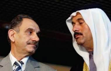 Sunni Arab leader Saleh al-Mutalq (L) speaks to Sunni lawmaker Abdul-Rahman al-Nueimi (R) at a news conference after an assembly session in Baghdad August 28, 2005. 
