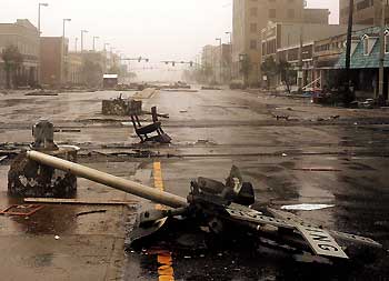 A train crossing light is torn down as Hurricane Katrina hit downtown Gulfport, Mississippi August 29, 2005. Hurricane Katrina ripped into the U.S. Gulf Coast on Monday, stranding people on rooftops as it pummeled the historic jazz city New Orleans with 100 mph (160 kph) winds and swamped Mississippi resort towns and lowlands with a crushing surge of seawater.