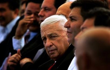 Israeli Prime Minister Ariel Sharon, center, during a ceremony to lay the cornerstone of the northern Israeli village of Nurit, Monday, Aug. 29, 2005.