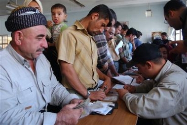 Iraqis wait to sign their names at the registration center in the northern city of Kirkuk, some 240 kilometers (150miles) from Baghdad, Tuesday, Aug. 30, 2005. Referendum on the new Iraqi costitution is scheduled for Oct. 15. (AP