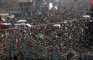 Ambulances remain on standby among the crowd of Iraqi pilgrims near the Kadhimiya mosque in Baghdad August 31, 2005. 