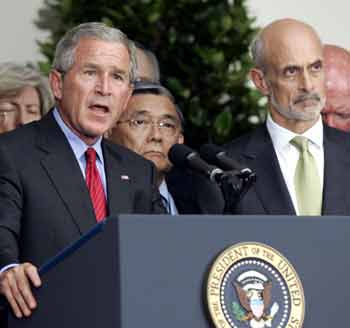 U.S. President George W. Bush speaks in the Rose Garden, after a meeting with members of the White House Task Force on Hurricane Katrina Recovery, in Washington August 31, 2005. Bush cut short his vacation to oversee the federal response to Hurricane Katrina ahead of an expected visit to devastated Gulf Coast areas later this week. At right is Homeland Security Secretary Michael Chertoff.