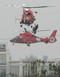 A Coast Guard helicopter plucks a Hurricane Katrina survivor from a rooftop in New Orleans, September 1, 2005. 