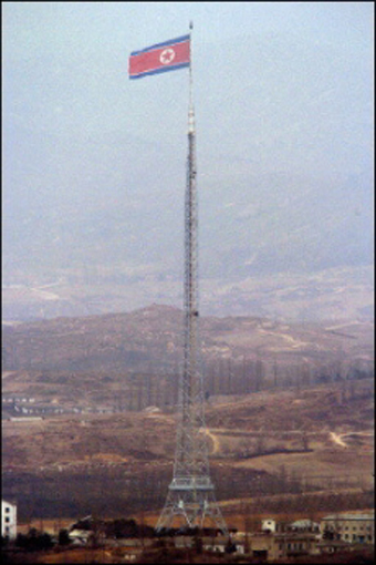 Giant North Korean flag flies south and north korean flags. Giant North Korean flag flies