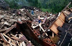 Chinese residents look for their belongings amid debris in a typhoon-hit village in Wencheng county, Wenzhou, east China's Zhejiang province, September 2, 2005.