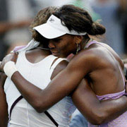 Venus Williams hugs sister serena after a US Open 4th round match in which Venus beat sister to advance to quaterfinals.