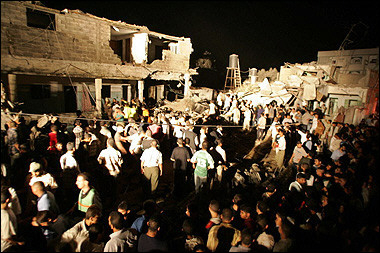 Palestinians gather around the rubble of house following an explosion in Gaza City. [AFP]